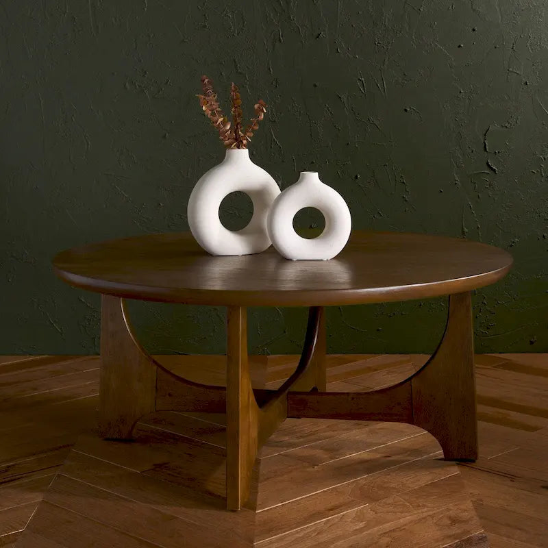 Runder Holzcouchtisch mit skulptural geschwungenem Trestelgestell im Mid-Century-Stil
